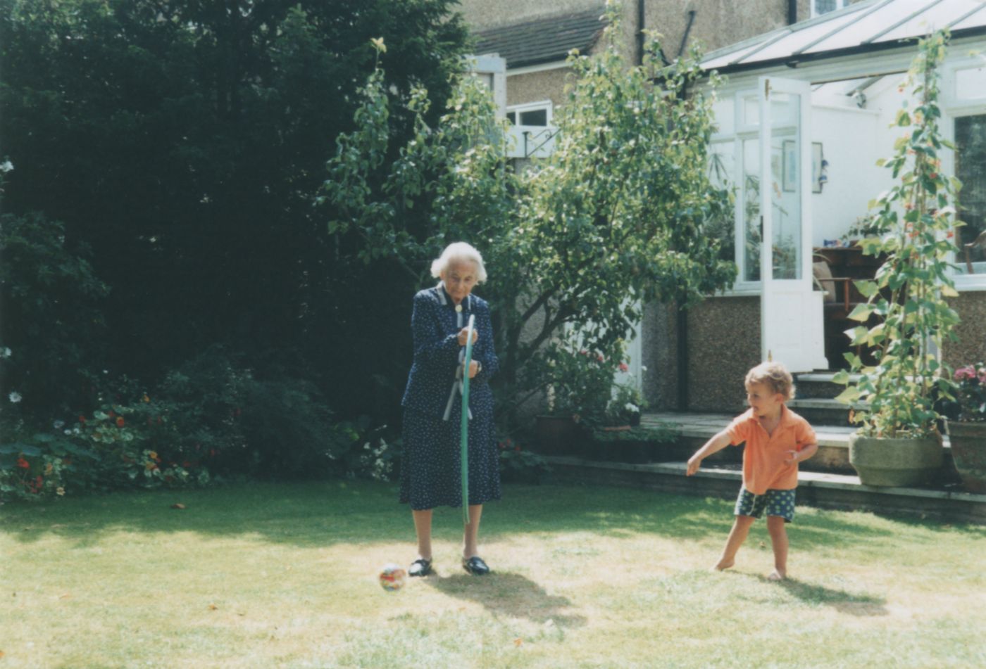 John throwing a ball through a hoop held by oldemor